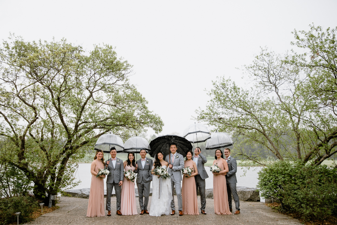 wedding party with matching umbrellas at the manor wedding in kettleby, ontario
