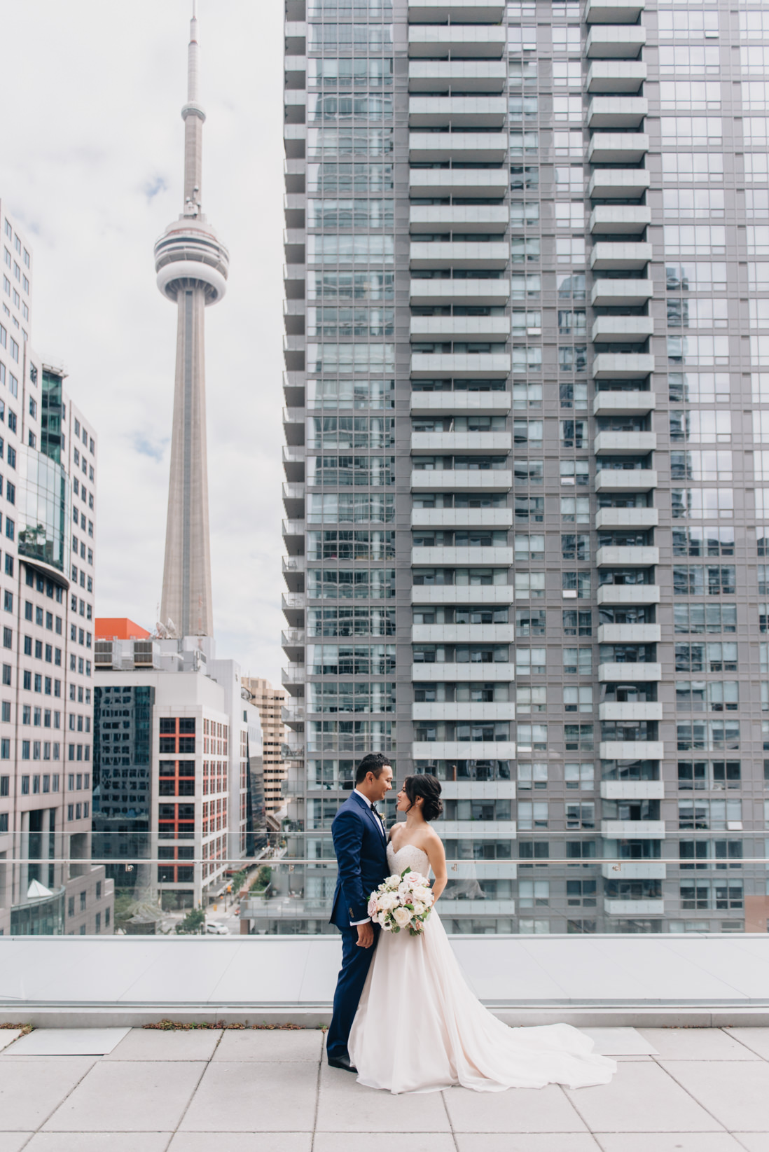 bride and groom in front of the cn tower malaparte wedding toronto wedding photographer