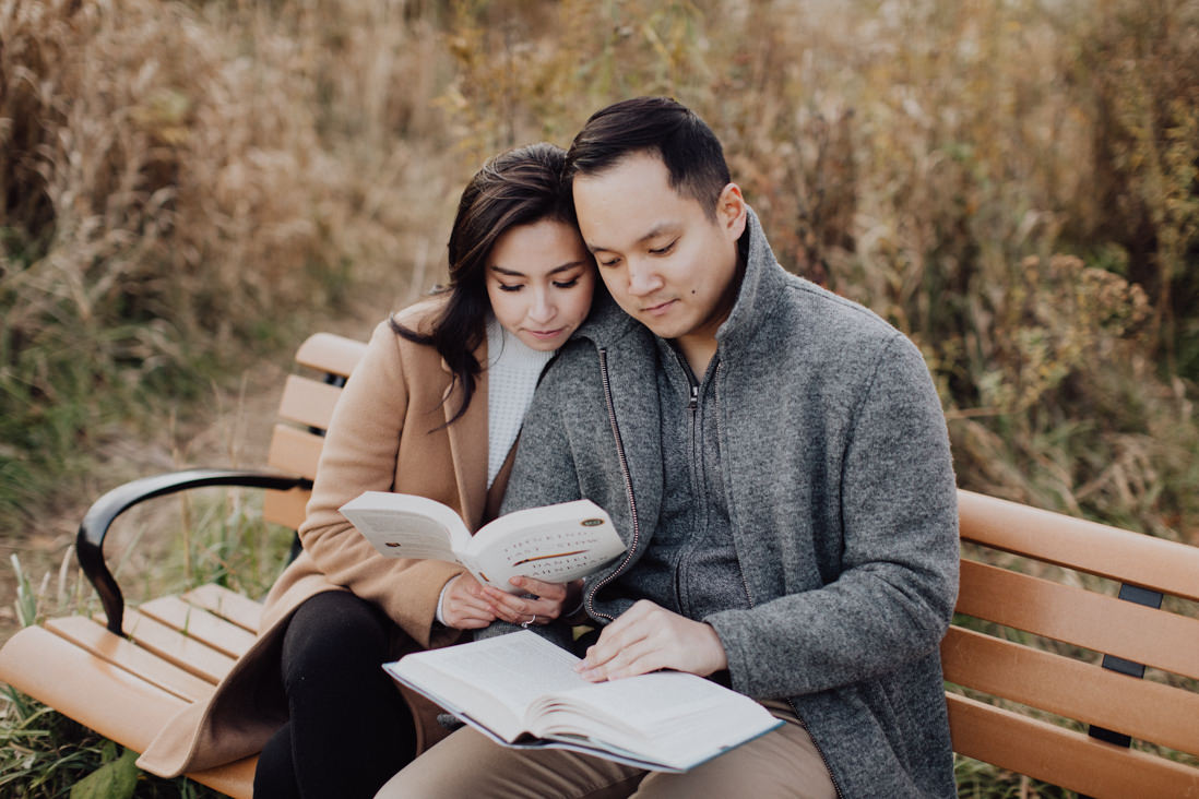 couple reading books on a bench fall engagement caledon | eightyfifth street photography
